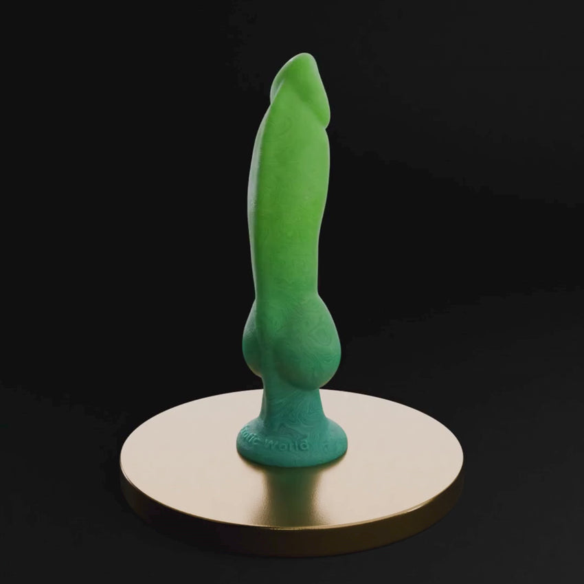A 360-degree 3D turnaround render of a sleek, ergonomic adult massager in a vibrant green finish. The product is displayed on a luxurious gold-trimmed circular pedestal against a dark, professional backdrop, highlighting its smooth curves and premium build